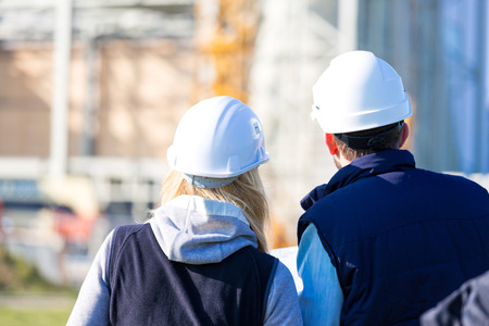 View of Two workers working outside on a construction siteの写真素材