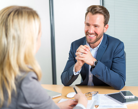 View of a Young attractive employer doing a job interview to a womanの写真素材