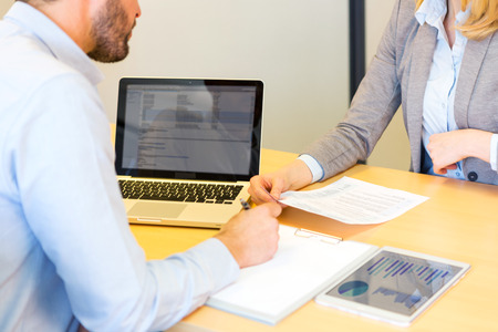 View of a Young attractive woman giving resume during job interview
