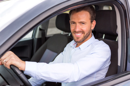 View of a Young attractive man driving his carの写真素材