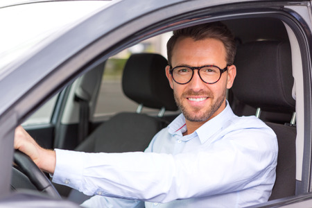 View of a Young attractive man driving his carの写真素材