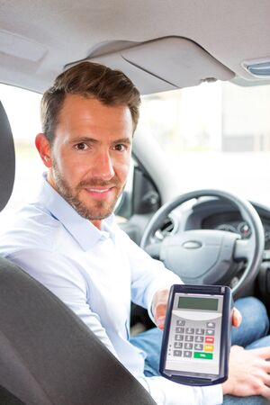 View of a Young attractive driver ask customer for payment in carの写真素材