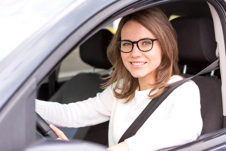 View of a Young attractive woman driving his carの写真素材