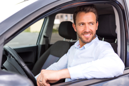 View of a Young attractive man driving his carの写真素材