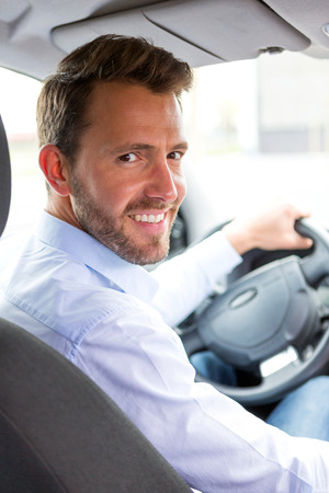 View of a Young attractive man driving his carの写真素材