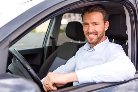 View of a Young attractive man driving his car