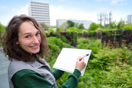 View of a Young attractive landscaper woman working in a public parkの写真素材