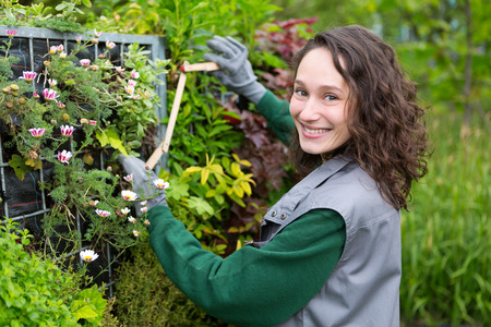 View of a Young attractive landscaper woman working in a public parkの写真素材