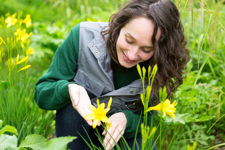 View of a Young attractive gardener woman taking care of flowersの写真素材