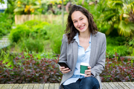 View of a Young attractive business woman working at the park during a pauseの写真素材