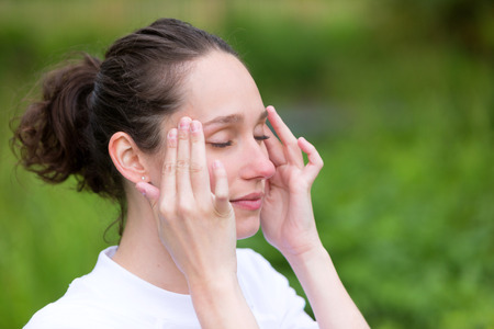 View of a Young attractive woman practising yoga in a parkの写真素材