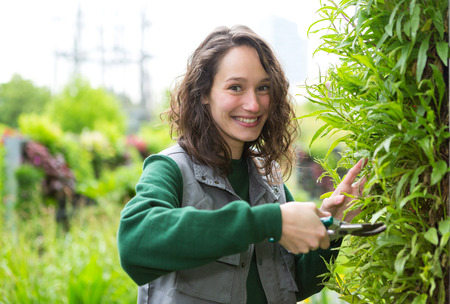 View of a Young attractive woman working in a public gardenの写真素材
