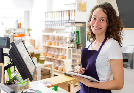View of a Young attractive woman working at the grocery store