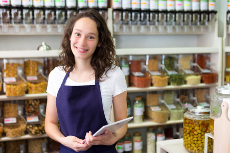 View of a Young attractive woman working at the grocery storeの写真素材