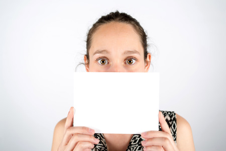 View of a Sad woman hidden behind a board isolated on a white background
