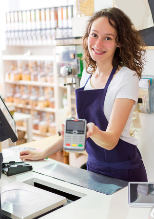 View of a Young attractive woman working at the grocery storeの写真素材