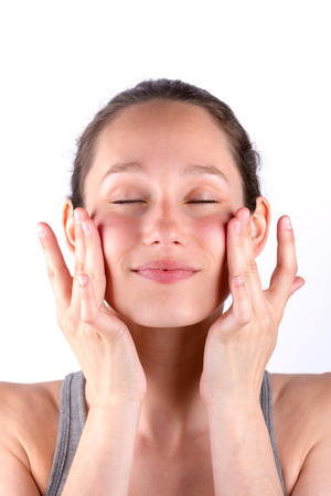 View of Young attractive woman applying cream on her skinの写真素材