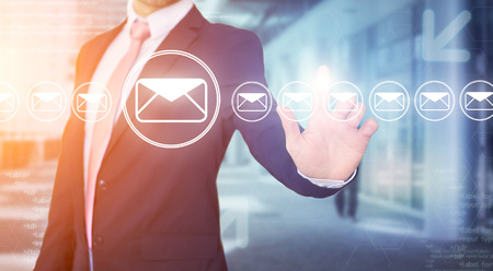View of a Businessman touching technology interface with professional email iconの写真素材