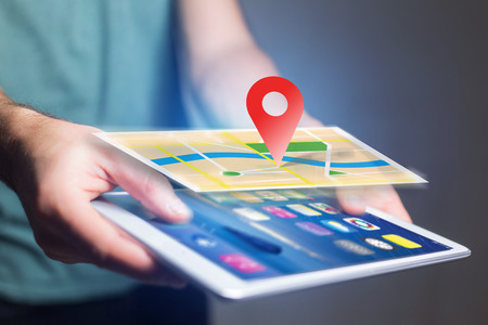 View of a Concept of geographical localization on a map with a tablet