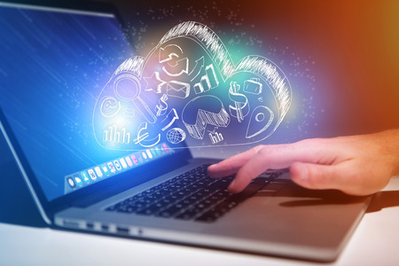 Concept view of cloud storage icon flying out a computer - technology concept