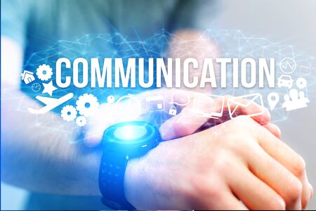 Concept view of man holding a futuristic interface with communication title and multimedia icons flying all around - Internet conceptの写真素材