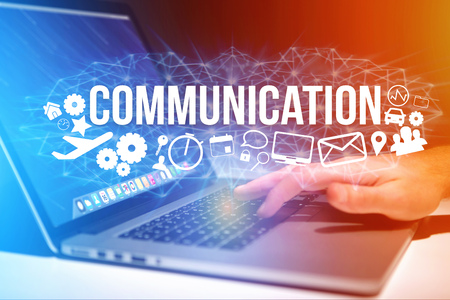 Concept view of man holding a futuristic interface with communication title and multimedia icons flying all around - Internet conceptの写真素材