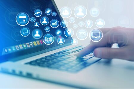 Concept view of multimedia icon flying over device on a technology interface - Internet concept