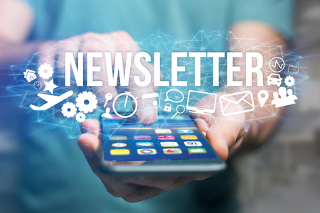 Concept view of man holding futuristic interface with newsletter title and multimedia icons flying all around - Internet conceptの写真素材