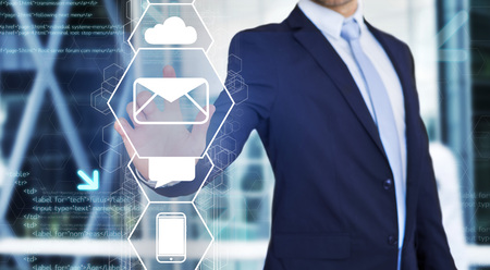 View of a Businessman touching technology interface with business email iconの写真素材
