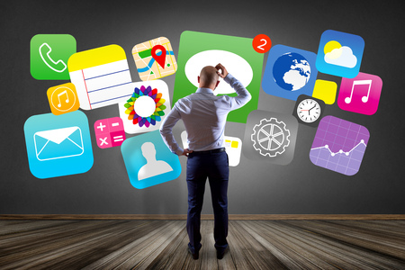 View of a Businessman in front of a wall thinking about application multimedia internet - Internet conceptの写真素材