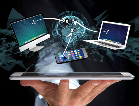 View of a Computer and devices displayed on a futuristic interface with interantional network - Multimedia and technology conceptの写真素材