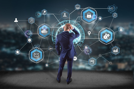 View of a Businessman in front of a wall with an International business network connection displayed...