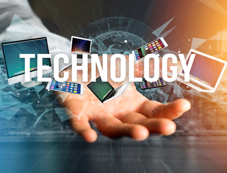 View of a Technology title surounded by device like smartphone, tablet or laptop - Internet and communication conceptの写真素材