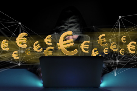 View of a Hacker man in the dark using computer to hack data and information systemの写真素材