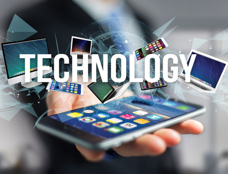 View of a Technology title surounded by device like smartphone, tablet or laptop - Internet and communication conceptの写真素材
