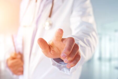 View of a Doctor pointing his finger at the hospitalの写真素材