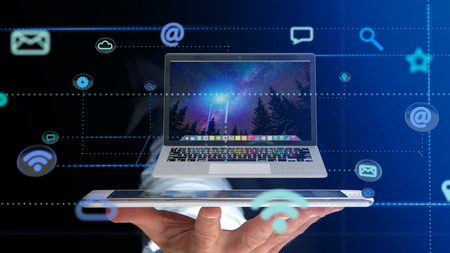 View of a Businessman using a smartphone with a Computer surrounding by app and social icon - 3d render の写真素材