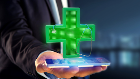 View of a Businessman using a smartphone with a Lighting pharmacy cross and a stethoscope - 3d render の写真素材