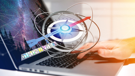 View of a Business man using a navigation compass on a laptop - 3d renderedの写真素材