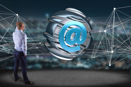view of a Businessman in front of an Arobase symbol displayed in a sliced sphere - 3D renderingの写真素材
