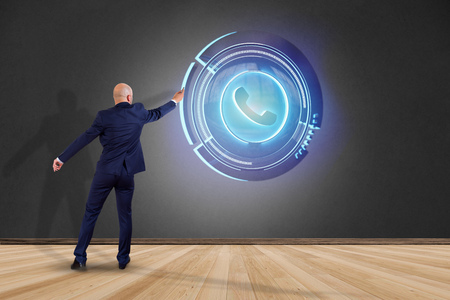 View of a Businessman in front of a wall with a Shinny technologic phone button - 3d renderの写真素材