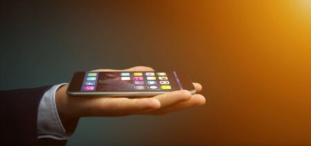 View of a Hands on the dark holding a smartphone