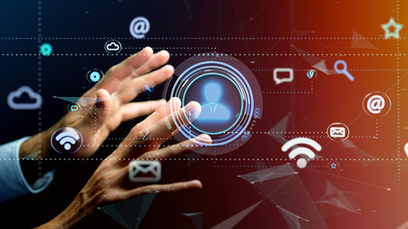 View of a Businessman holding a Contact icon surrounding by app and social icon - 3d render の写真素材