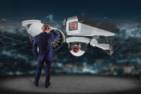 View of a Businessman holding a Security camera system and network connection - 3d rendering