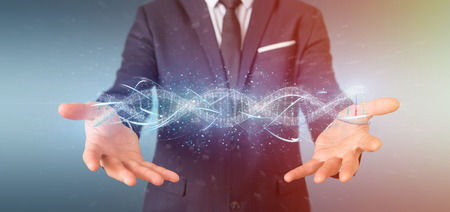 View of a Businessman holding a 3d render DNAの写真素材
