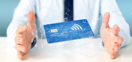 View of a Man holding a contactless credit card payment concept 3d renderingの写真素材