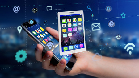 View of a Businessman using a smartphone with a tablet surrounding by app and social icon - 3d renderの写真素材