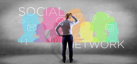 View of a Businessman in front of a colorfull social network teamwork with icon 3d renderingの写真素材