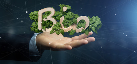 View of a Businessman holding Wooden logo bio with leaves around 3d renderingの写真素材