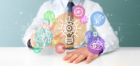 View of a Cloud of colorfull start up icon bubble with data Businessman holding a binary 3d renderingの写真素材